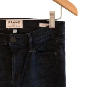 Frame Le High Flare denim in distressed black.